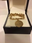 Pulseira com o pai nosso escrito banhado a ouro 18kl
